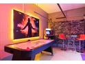 Air hockey table and arcade games in the game room with movie themed decor at 3004 Protagonist St, Kissimmee, FL 34746