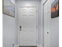 A clean, bright entryway featuring a white front door and a convenient storage closet at 3028 Parkway Blvd # 308, Kissimmee, FL 34747