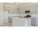 Modern kitchen with grey cabinets, island, stainless steel appliances, and lots of counter space at 3088 Windswept, Wildwood, FL 34785