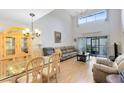 Bright living room with high ceilings, fan, large windows, sliding glass doors, and wood flooring at 3336 Gray Fox Cv # 3336, Apopka, FL 32703