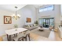 Bright living area features vaulted ceilings, dining area, and sliding glass doors to the lanai at 3336 Gray Fox Cv # 3336, Apopka, FL 32703