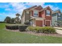 Exterior view of a two-story townhouse with a well-maintained lawn and landscaping at 4178 Sw 43Rd Cir, Ocala, FL 34474