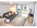 Bright living room featuring a comfy sectional couch, stylish rug, and sliding glass doors to a patio at 4364 White Pine Ave # 3, Orlando, FL 32811