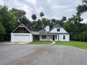A daytime shot of the home's exterior, with green grass in the front at 470 Sunset Rd, Deltona, FL 32725