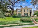 Charming stucco home showcasing beautiful landscaping, a brick walkway, and a welcoming facade at 522 Cherokee Dr, Orlando, FL 32801