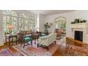 Inviting living room with hardwood floors, large windows, and a classic fireplace, offering ample natural light at 522 Cherokee Dr, Orlando, FL 32801