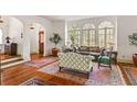 Elegant living room featuring hardwood floors, arched doorways, and large windows for a bright, airy feel at 522 Cherokee Dr, Orlando, FL 32801