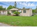 Charming single-story home features a well-maintained lawn and established landscaping at 663 Romano Ave, Orlando, FL 32807