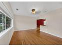 Bright living room featuring gleaming hardwood floors and large window for natural light at 663 Romano Ave, Orlando, FL 32807