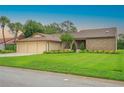 Charming single-story home featuring a three-car garage and lush, green lawn at 6766 Edgeworth Dr, Orlando, FL 32819