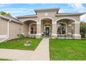Charming home featuring a well-manicured lawn, inviting front porch, and decorative architectural details at 701 Little Hampton Ln, Gotha, FL 34734