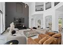 Stunning living room featuring soaring ceilings, a modern fireplace, and luxury finishes at 8131 Vineland Oaks Blvd, Orlando, FL 32835