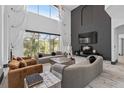 Elegant living room showcasing high ceilings, expansive windows, and stylish modern furniture at 8131 Vineland Oaks Blvd, Orlando, FL 32835