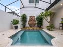 Tranquil plunge pool with fountain and stylish tile surround at 8818 Bismarck Palm Dr, Winter Garden, FL 34787
