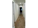 Hallway featuring ceramic tile flooring with multiple doors leading to other rooms in the home at 955 Gamewell Ave, Maitland, FL 32751