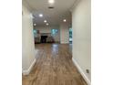 Bright, open hallway showcasing newly installed ceramic tile flooring leading to the living area at 955 Gamewell Ave, Maitland, FL 32751