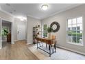 Stylish home office with a wooden desk, sleek shelving, and views to the manicured outdoors at 9670 Cypress Pine St, Orlando, FL 32827