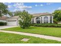 Charming single-story home featuring a well-manicured lawn and inviting curb appeal at 10080 Cove Lake Dr, Orlando, FL 32836