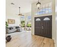 Elegant entryway with high ceilings, decorative double doors, and light wood floors at 10080 Cove Lake Dr, Orlando, FL 32836