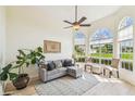 Bright living room with large windows, vaulted ceilings, and hardwood floors at 10080 Cove Lake Dr, Orlando, FL 32836