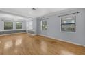 Bright and airy living room with hardwood floors and large windows offering plenty of natural light at 1021 N Forest Ave, Orlando, FL 32803