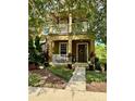 Inviting two-story home featuring a cozy front porch, upper balcony, and beautifully landscaped front yard at 10350 Lake District Ln # S, Orlando, FL 32832