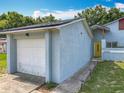 Exterior showing attached garage and entrance with well-maintained landscaping at 10460 Riva Ridge Trl, Orlando, FL 32817