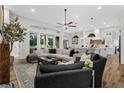 Airy living room featuring neutral color palette, wood floors and flooded with natural light at 1141 Waldorf Ct, Winter Springs, FL 32708