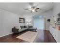 Comfortable living room with a modern sectional, ceiling fan, and access to the patio at 13826 Mirror Lake Dr, Orlando, FL 32828