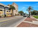 Exterior view of The Metropolitan at Lake Eola with palm trees on a sunny day at 151 E Washington St # 5B, Orlando, FL 32801