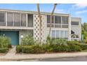 Contemporary condo building showcasing neutral tones, large windows, and mature landscaping at 151 N Orlando Ave # 212, Winter Park, FL 32789