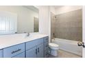 This bathroom offers a vanity with ample cabinet space, and tiled shower and bathtub combination at 176 Duckweed Ave, Fruitland Park, FL 34731