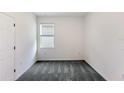 Bright bedroom featuring soft gray carpeting, fresh paint, and ample natural light from a large window at 176 Duckweed Ave, Fruitland Park, FL 34731