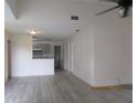 Open living space featuring sleek flooring and a partial view of the kitchen at 2002 Cascades Blvd # 201, Kissimmee, FL 34741