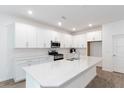 Well-lit kitchen with a large island, stainless steel appliances, and white cabinetry at 2261 Sirena Ln, Mount Dora, FL 32757