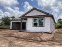 New home featuring an attached garage and gray vinyl siding at 2379 Broadbrook Drive, St Cloud, FL 34771