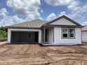 New home featuring an attached garage and gray vinyl siding at 2379 Broadbrook Drive, St Cloud, FL 34771