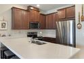 Well-equipped kitchen with stainless steel appliances, ample counter space, and rich wood cabinetry at 2696 Giardino Loop, Kissimmee, FL 34741