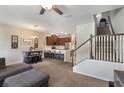 Open-concept living area showcasing a modern kitchen, dining space, and staircase at 2696 Giardino Loop, Kissimmee, FL 34741