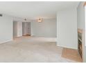 Bright and spacious living area with a fireplace and neutral carpeting at 300 Carolina Ave # 205, Winter Park, FL 32789