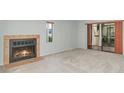 Cozy living room with a fireplace and sliding doors to an outdoor space at 300 Carolina Ave # 205, Winter Park, FL 32789