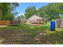 Spacious backyard featuring a wood deck, fenced yard, and a trampoline, ideal for outdoor enjoyment and relaxation at 30926 County Road 435, Sorrento, FL 32776