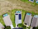Aerial shot of a well-maintained property with a pool and a neatly landscaped backyard in a quiet neighborhood at 318 Langham Dr, Davenport, FL 33897
