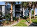 Exterior of a condominium building featuring a private, screened-in porch and lush landscaping at 3748 Idlebrook Cir # 202, Casselberry, FL 32707