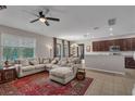 Open-concept living room with tile floors, a ceiling fan, and a comfortable sectional sofa at 391 Cabello Dr, Davenport, FL 33837