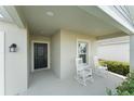 Inviting front porch featuring classic white rocking chairs and a view of the home's facade and entrance at 3941 Willowbrook Dr, Edgewater, FL 32141