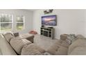 Comfortable living room with a large sectional couch, TV, and neutral decor at 3941 Willowbrook Dr, Edgewater, FL 32141