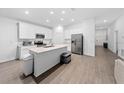 Bright open kitchen features modern stainless steel appliances, light countertops, and hardwood floors at 3977 Willowbrook Dr, Edgewater, FL 32141