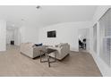 Open living area featuring neutral walls and floors, with comfortable seating, and large windows for natural light at 3977 Willowbrook Dr, Edgewater, FL 32141