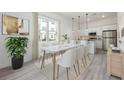 Bright dining room with a view of the kitchen, marble table, and light-colored accents at 404 Famagusta Dr, Davenport, FL 33896
